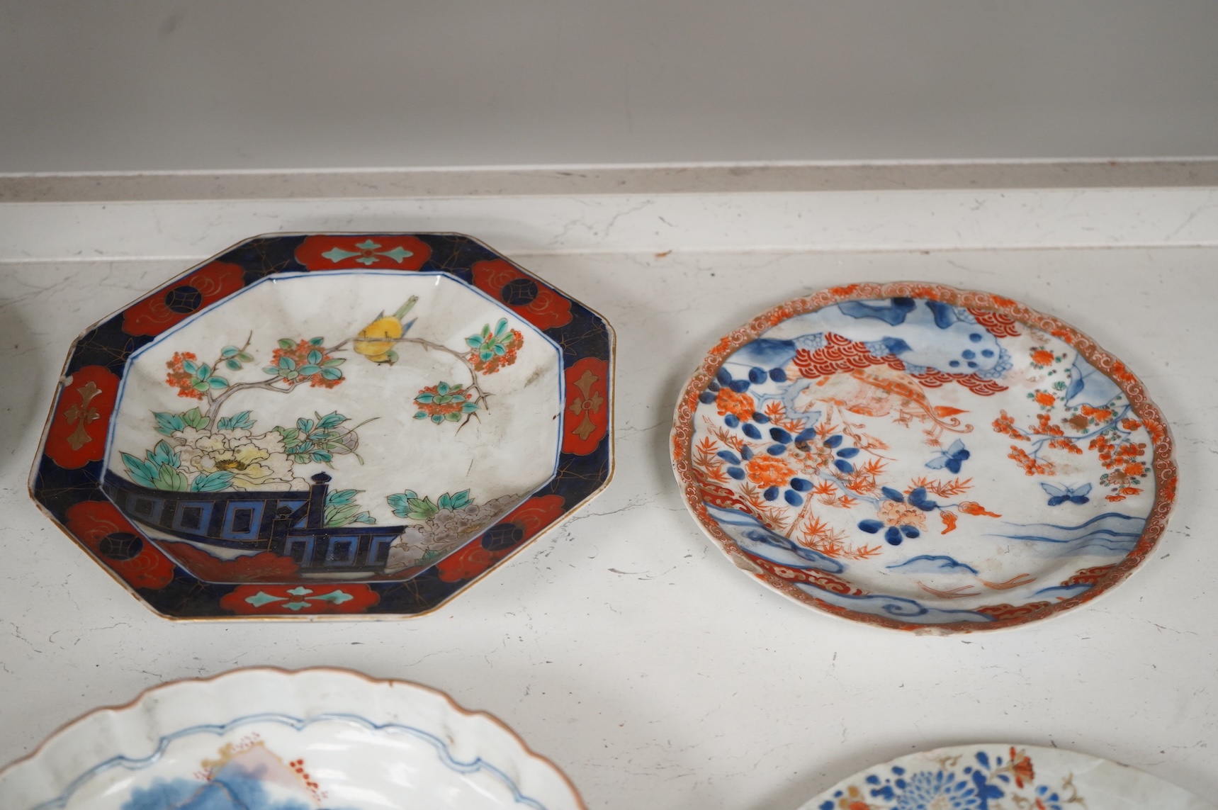 Six 19th century Japanese plates and a bowl, mostly Imari pattern, the octagonal dish with Koransha mark for Fukagawa, largest 24cm in diameter